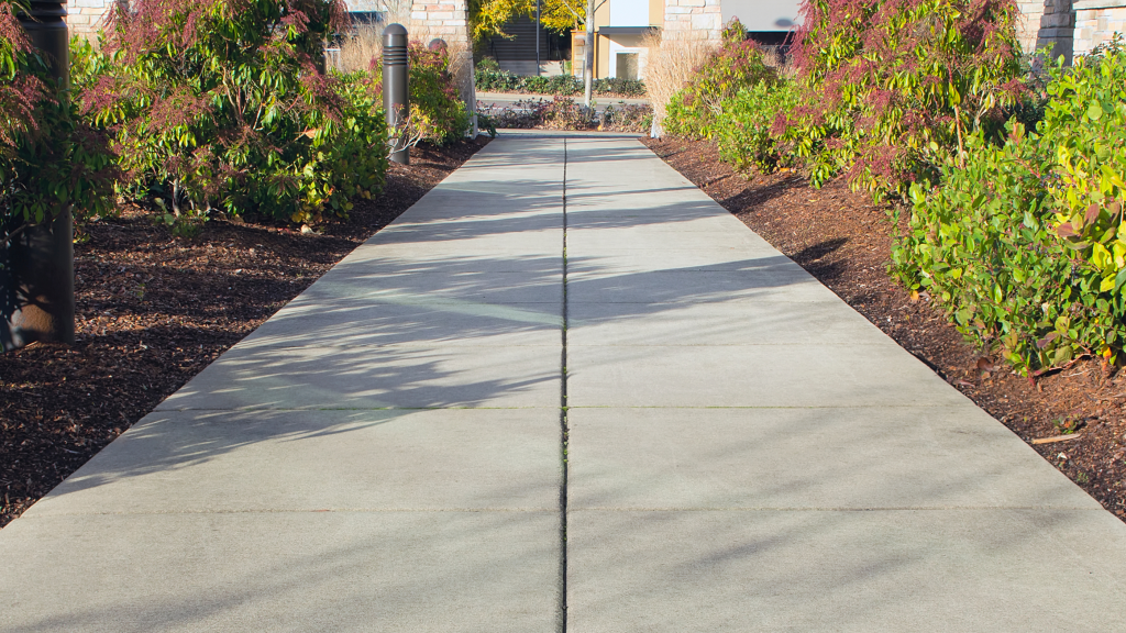 Finished concrete sidewalk with control joints at a residential or commercial property