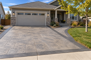 Concrete driveway and matching walkway with a decorative finish at a Northern Colorado home
